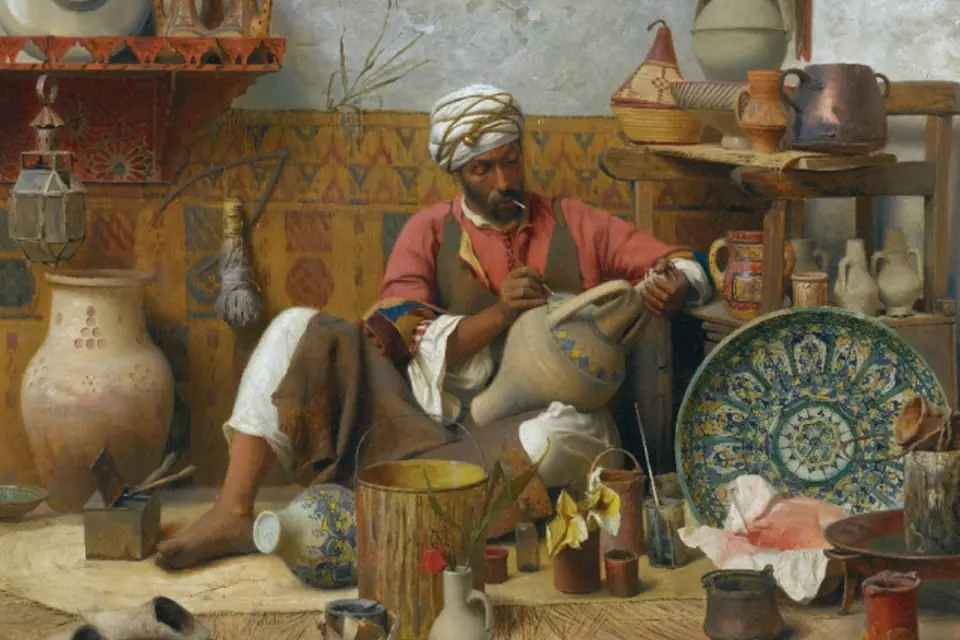 Peinture d'un potier assis au sol dans un atelier encombré de jarres, de plats décorés et de cruches en terre cuite